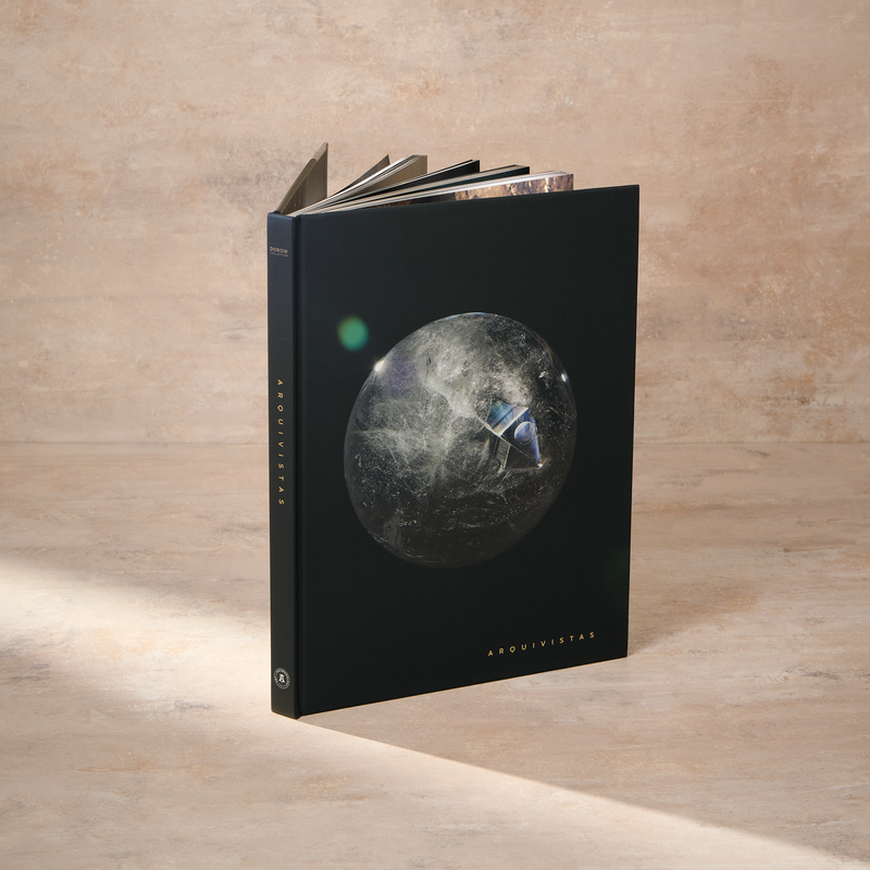 Image of ARQUIVISTAS book standing on end. Rare Enhydro Quarz Sphere on cover. 