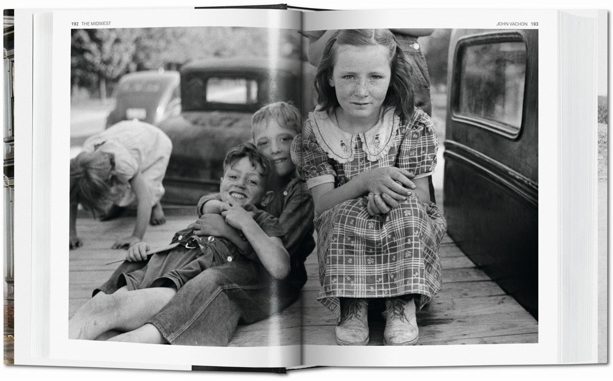 John Vachon photograph. Open book showing a black and white photograph of three children on a truck bed.