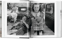 John Vachon photograph. Open book showing a black and white photograph of three children on a truck bed.