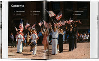 Open book showing a page with a vintage photograph of people holding American flags.